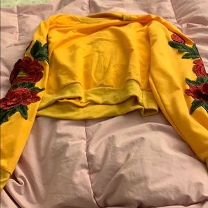 Yellow sweatshirt with rose detail on sleeve
